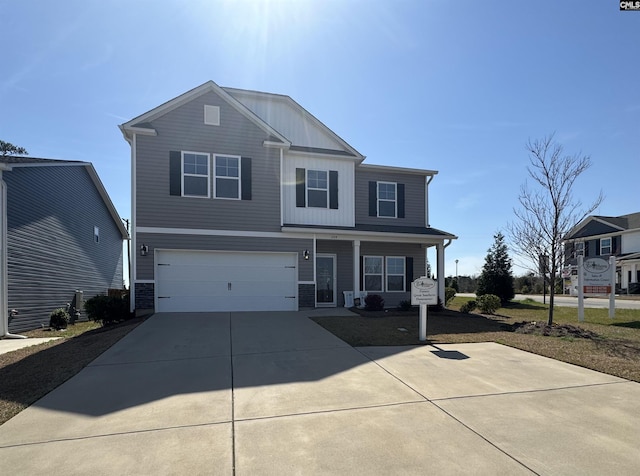 view of front of property with concrete driveway, an attached garage, and board and batten siding