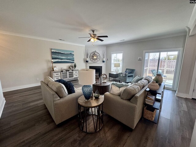 living area with a fireplace, dark wood-type flooring, and ornamental molding