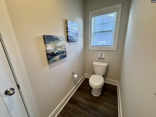 bathroom featuring baseboards, toilet, and wood finished floors