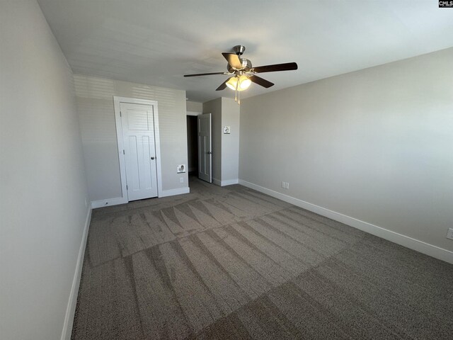 unfurnished bedroom with a closet, baseboards, carpet floors, and ceiling fan