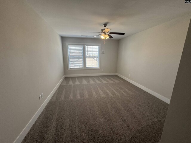 spare room featuring baseboards, light carpet, and ceiling fan