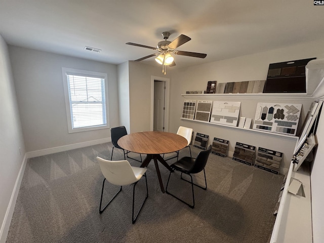 carpeted dining area with visible vents, baseboards, and a ceiling fan