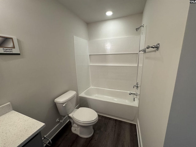 bathroom featuring vanity, wood finished floors, baseboards, bathtub / shower combination, and toilet