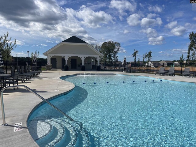 community pool featuring a patio area and fence