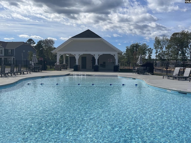 pool with a gazebo, a patio, and fence