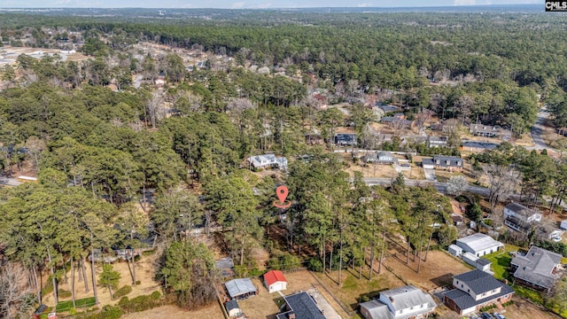 birds eye view of property featuring a wooded view