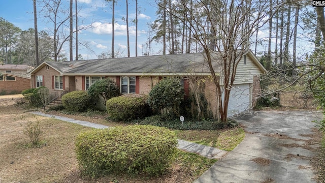 ranch-style house with brick siding, concrete driveway, and an attached garage