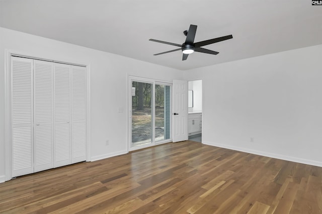 unfurnished bedroom featuring a ceiling fan, access to outside, wood finished floors, a closet, and baseboards