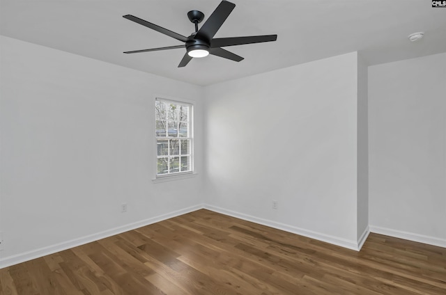 spare room with ceiling fan, baseboards, and wood finished floors