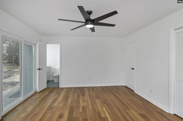 unfurnished bedroom with ceiling fan, wood finished floors, baseboards, and connected bathroom