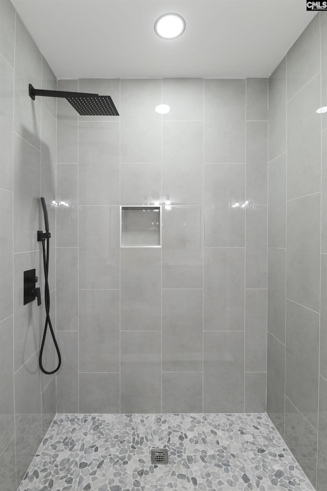 bathroom with a tile shower