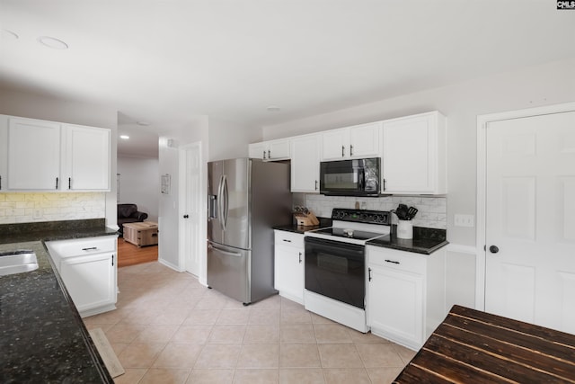 kitchen with electric range, white cabinets, stainless steel fridge with ice dispenser, and black microwave