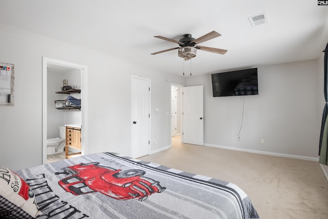 bedroom featuring visible vents, ensuite bath, baseboards, light colored carpet, and ceiling fan