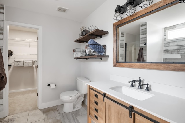 full bathroom featuring a spacious closet, visible vents, walk in shower, toilet, and vanity