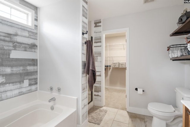 bathroom with vanity, a shower stall, a walk in closet, a garden tub, and toilet