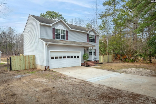 traditional home featuring fence, a garage, and driveway