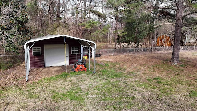 view of yard featuring a garage and fence