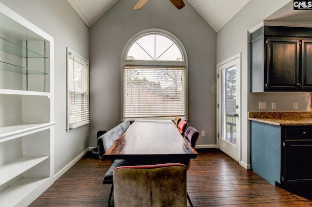 dining area featuring baseboards, dark wood-type flooring, ceiling fan, and vaulted ceiling