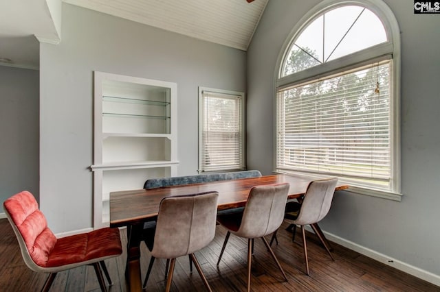 dining area featuring hardwood / wood-style flooring, a healthy amount of sunlight, baseboards, and vaulted ceiling