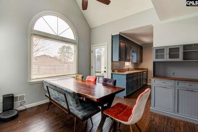 dining area with visible vents, ceiling fan, baseboards, dark wood-style floors, and high vaulted ceiling