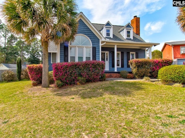 view of front of property with a front yard and a chimney