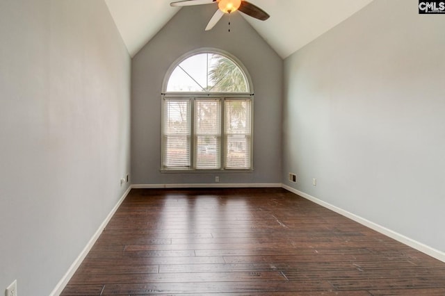 empty room featuring baseboards, dark wood-type flooring, ceiling fan, and vaulted ceiling