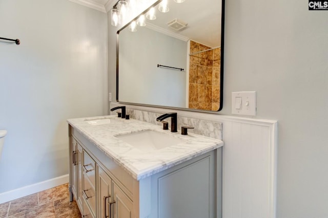 bathroom featuring a sink, visible vents, and ornamental molding