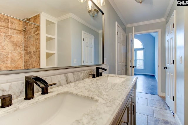 bathroom featuring double vanity, ornamental molding, baseboards, and a sink