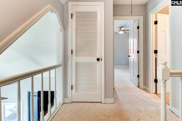 hall with carpet and baseboards