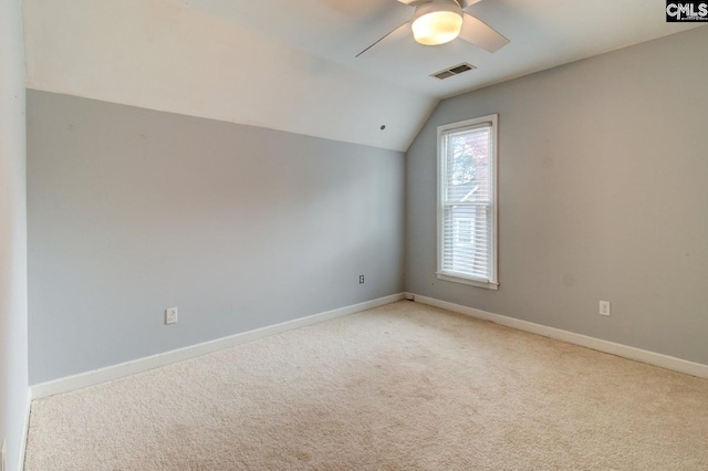 additional living space featuring visible vents, light colored carpet, baseboards, and lofted ceiling