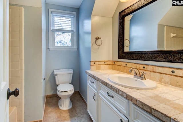 full bath with toilet, tile patterned flooring, decorative backsplash, baseboards, and vanity