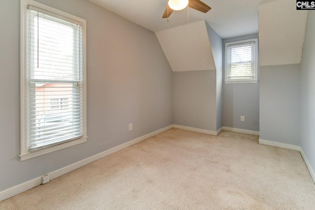 additional living space featuring baseboards, carpet, ceiling fan, and vaulted ceiling