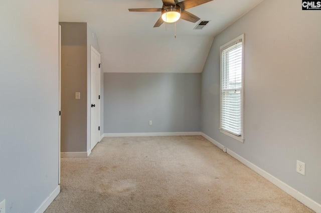 additional living space with visible vents, carpet, baseboards, ceiling fan, and vaulted ceiling