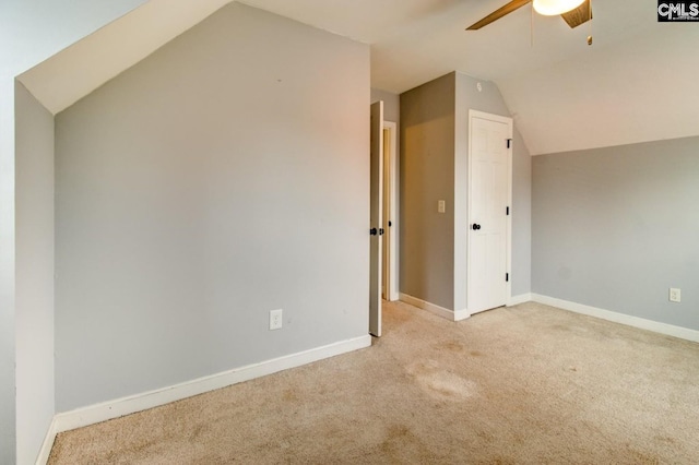 bonus room featuring lofted ceiling, carpet flooring, a ceiling fan, and baseboards