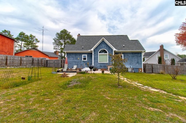 rear view of property featuring a fenced backyard, central air condition unit, a chimney, and a yard