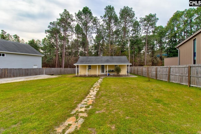 exterior space with a lawn, a fenced backyard, and a patio area