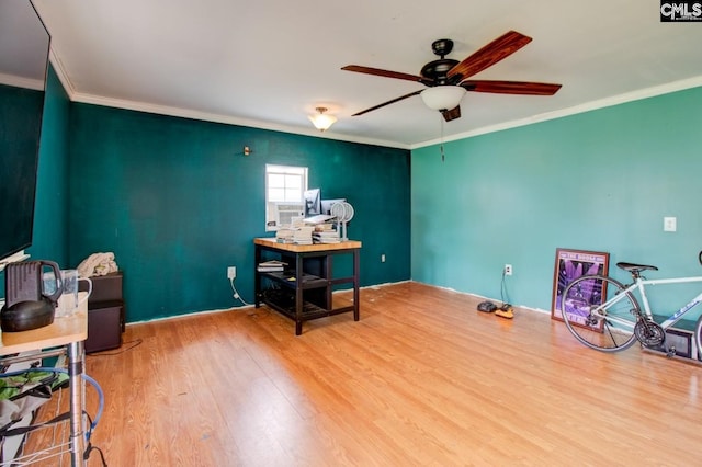 office featuring ornamental molding, wood finished floors, and ceiling fan