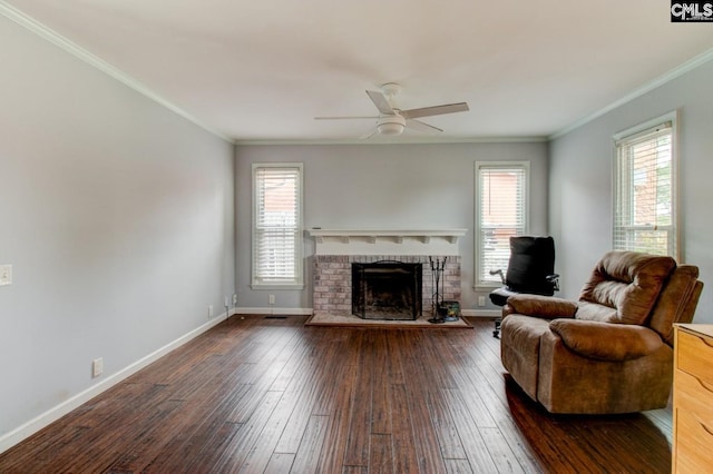 living area featuring plenty of natural light, ornamental molding, a fireplace, and hardwood / wood-style flooring