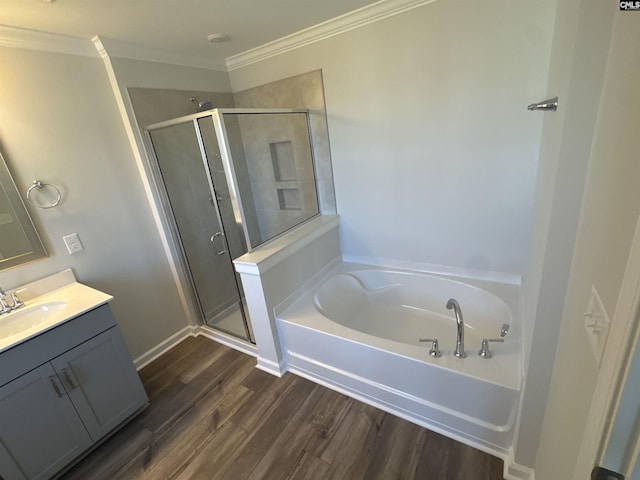 full bathroom with a stall shower, ornamental molding, wood finished floors, a bath, and vanity