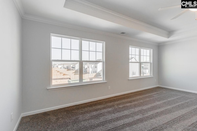 carpeted spare room featuring ceiling fan, a tray ceiling, baseboards, and ornamental molding