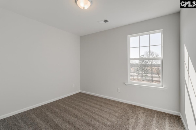 unfurnished room featuring carpet, visible vents, and baseboards