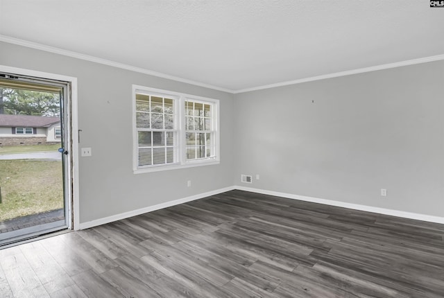 spare room with baseboards, dark wood-type flooring, and ornamental molding