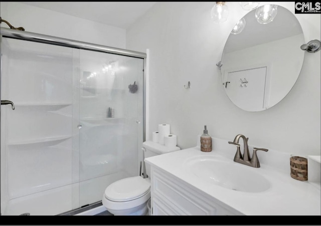 bathroom featuring toilet, a stall shower, and vanity