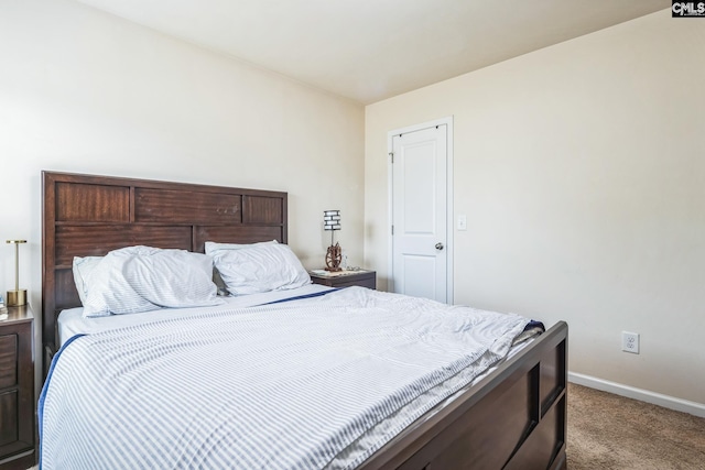 bedroom featuring carpet flooring and baseboards