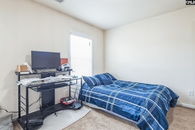 bedroom with carpet flooring and baseboards