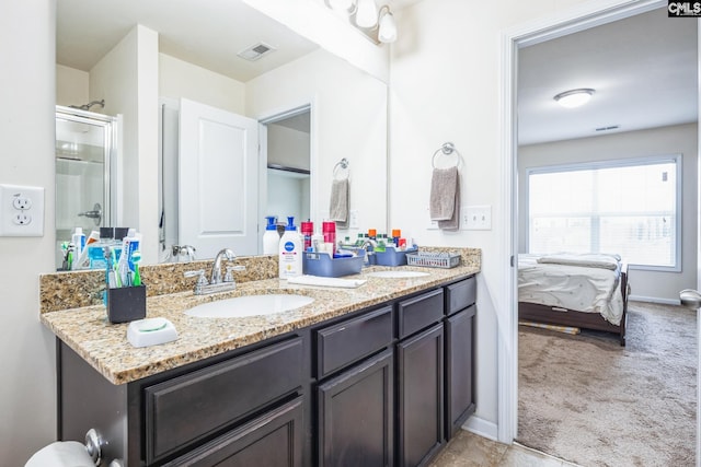 bathroom with double vanity, visible vents, ensuite bathroom, and a sink