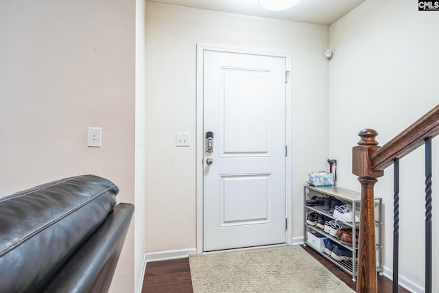 foyer with wood finished floors and baseboards