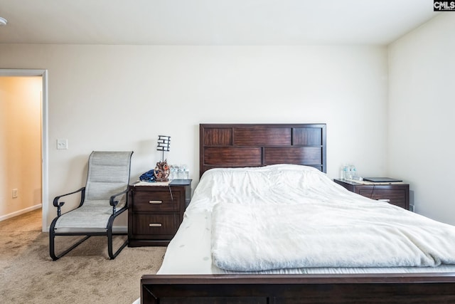 carpeted bedroom featuring baseboards