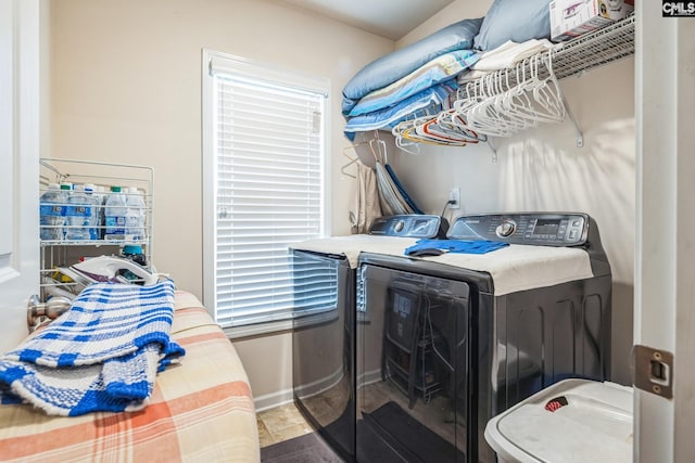 washroom featuring washer and clothes dryer, laundry area, and baseboards