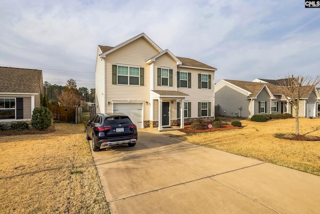 traditional home with a garage, driveway, and fence